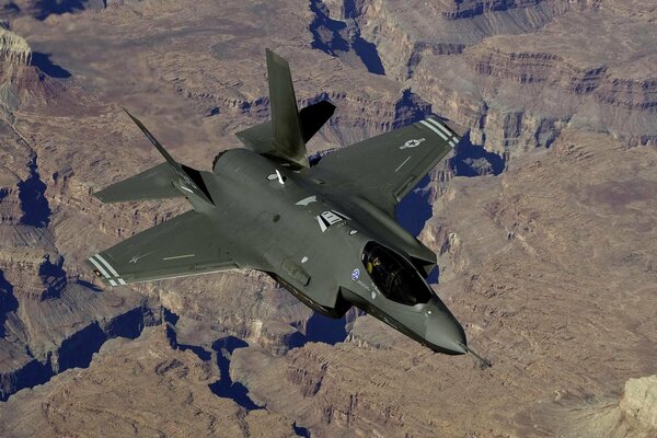 Military fighter on mountainous terrain