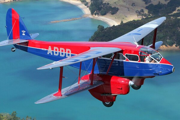 A beautiful and bright plane is flying over the sea