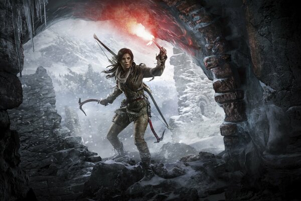 Lara Croft walks into a dark cave with a torch