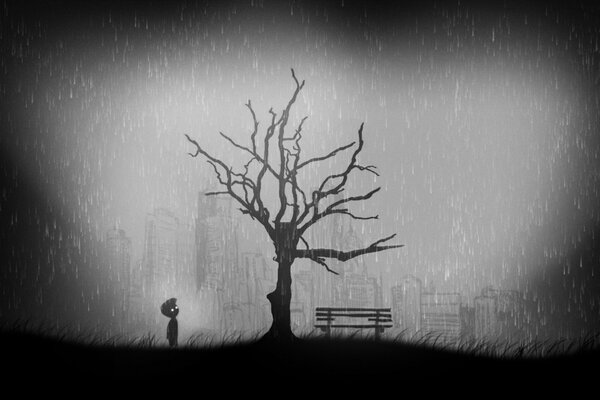 A lonely boy in the rain near a dried-up tree