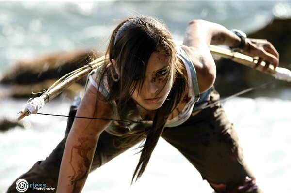 Cosplay on Lara Croft beautiful girl with blood on her skin