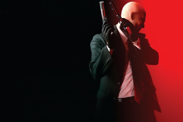Hitman na czarno-czerwonym tle z bronią