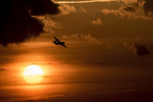 Airplane in the sky and sunset