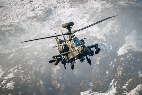 Helicóptero militar vuela en el cielo sobre las montañas