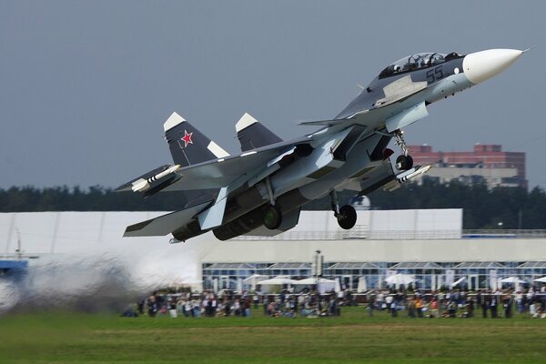 Su-30 fighter taking off at the airfield