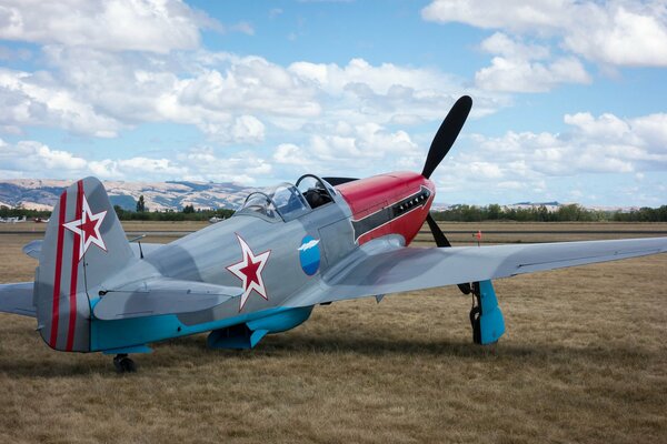 The Soviet Yak-3 fighter stands in the field