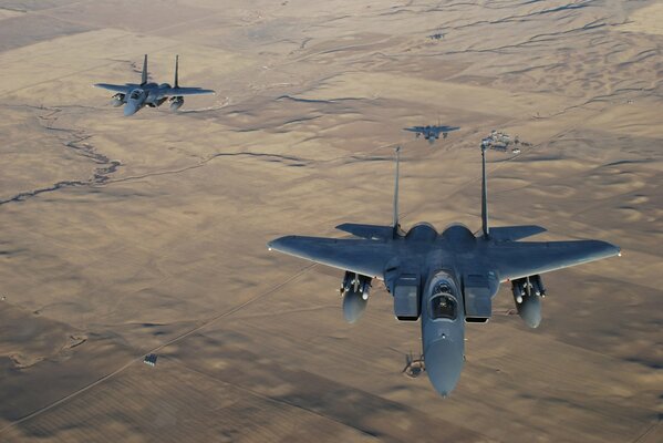 F-15 fighters fly over the desert