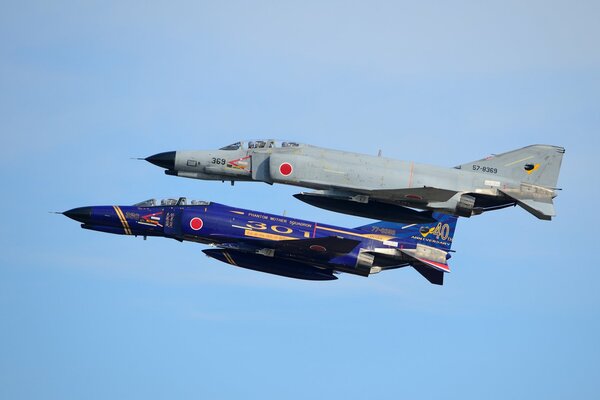 Grey and blue fighters in the sky