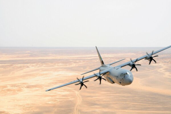 A military transport plane is flying