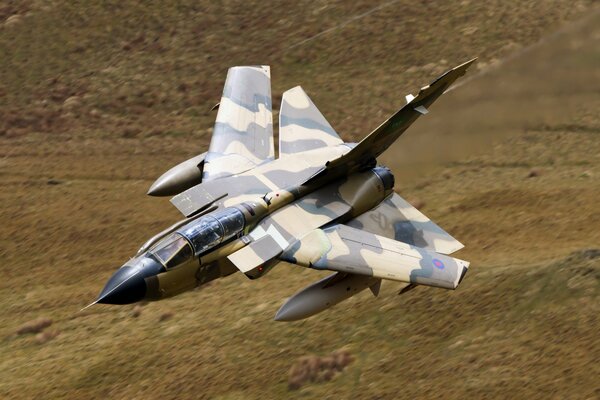 A fighter-bomber in camouflage paint rolls