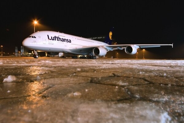 Samolot A 380 nocą na zimowym lotnisku