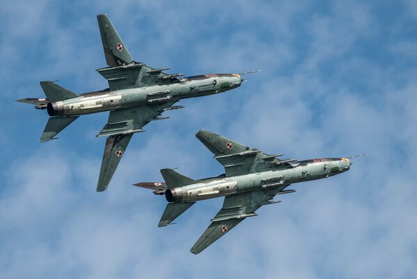 Two flying fighter jets high in the sky