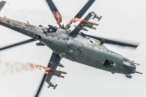 Grey Mi-24 combat helicopter in flight