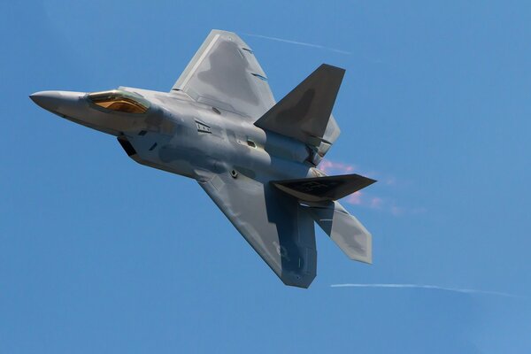 A combat fighter flying in the blue sky