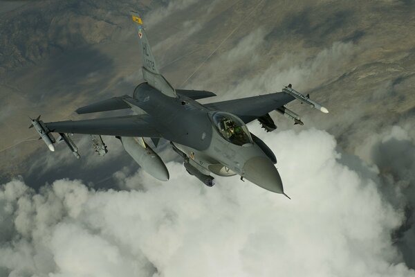 Flying fighter over white clouds