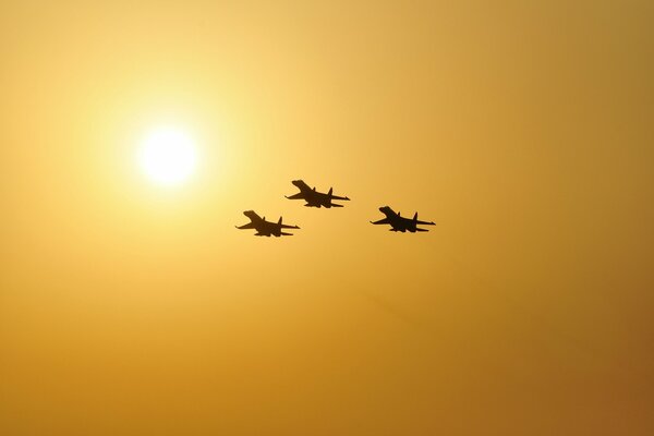Su-27 aircraft in formation at sunset