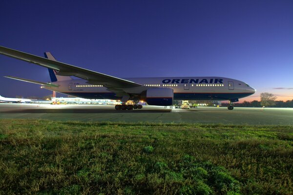 Boeing-777 passenger airliner at night airfield