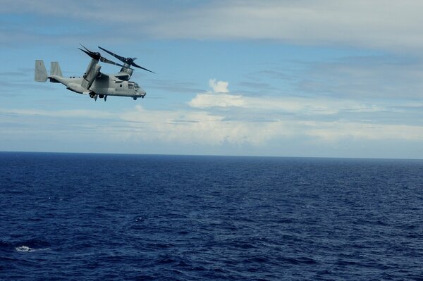 Vuelo de un helicóptero militar sobre las inmensas profundidades del mar