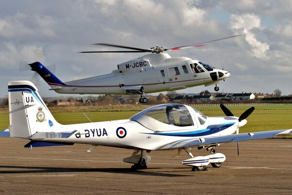 Helicopter and airplane at the airfield