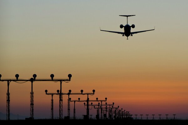 The plane takes off at sunset