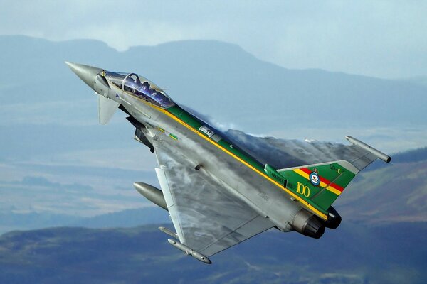 Typhoon is gaining altitude against the backdrop of mountains