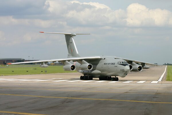 The plane is on the runway of the airfield