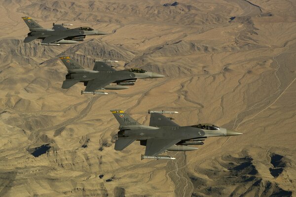 Three fighters fighting falcon over the desert