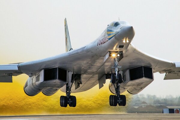 Tu-160 bomber takes off releasing golden smoke