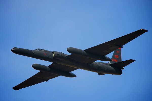 An interesting plane is flying through the blue sky