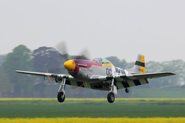 A military fighter takes off from the grass