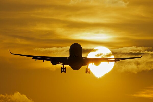 Passenger plane on the background of sunset