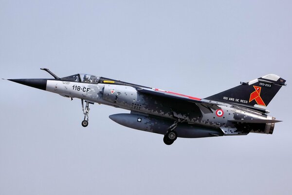 The mirage f1 plane is flying in the sky