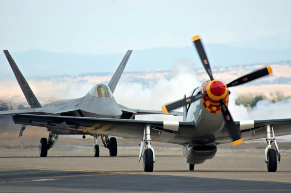 F-22 raptor and P-51 Mustang fighters at the airfield