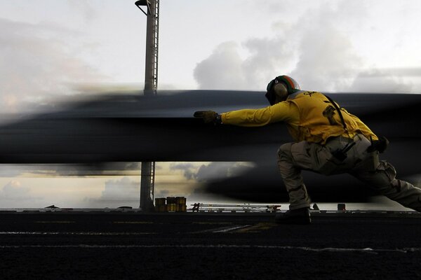 The launch of a military aircraft from the take-off platform of an aircraft carrier