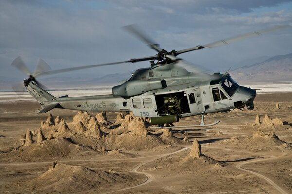 Bell ah multi-purpose helicopter flies over the mountains