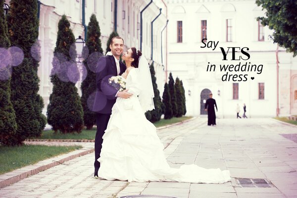 Happy wedding couple, bride and groom on the background of the church. there is love between them