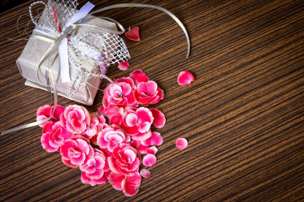 Gift box and petals on the table