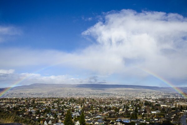 Valley landscape, rainbow, white clouds