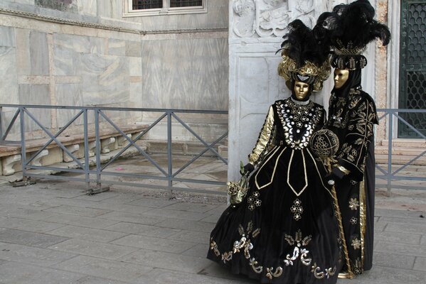 A couple in fancy dress with feathers