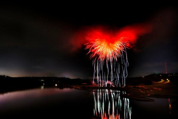 Fireworks on the water at night