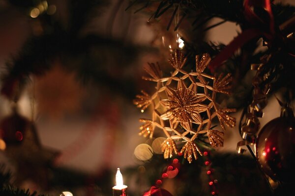 Golden Christmas tree toy in the form of snowflakes