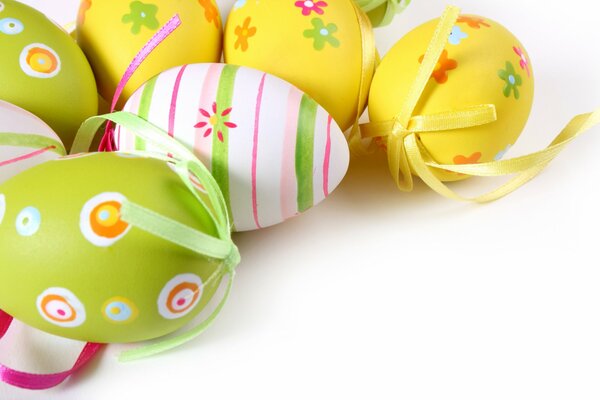 Easter beautiful eggs with ribbons on a white background