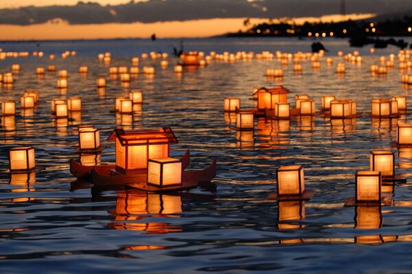 Burning lanterns float on the water