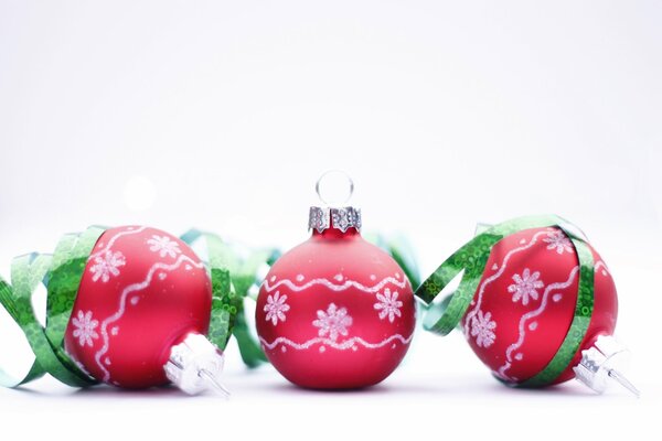 Christmas balls - red toys on a white lawn