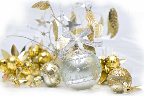 Silver New Year s ball with a bow on a background of golden ornaments