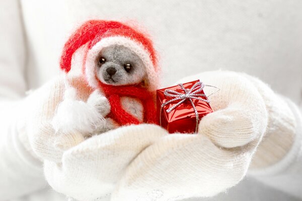 White mittens with a toy and a gift