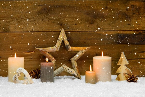 Composition of lighted candles in the snow