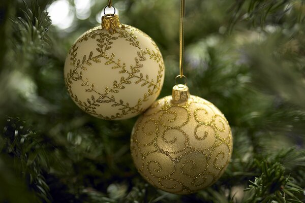 Golden balls hang on a festive Christmas tree