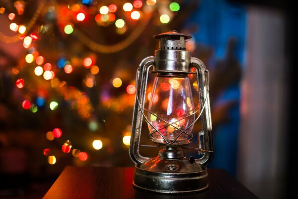 Kerosene lamp on the background of a festive Christmas tree