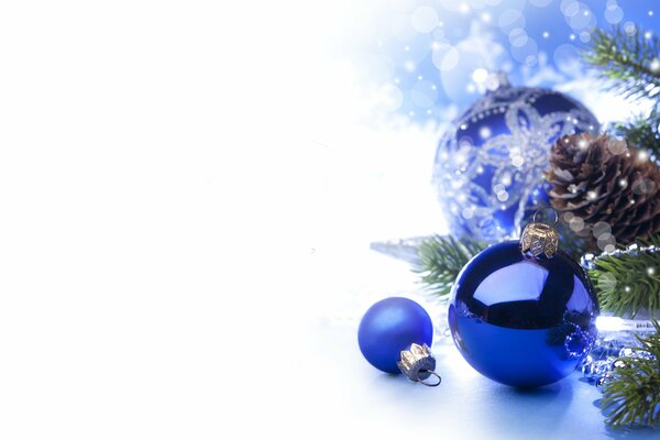 Christmas background with blue balloons and a fir twig